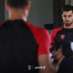 Persepolis player with a league guard